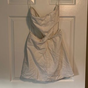 Strapless white dress with a twisted front and open back.  Lined